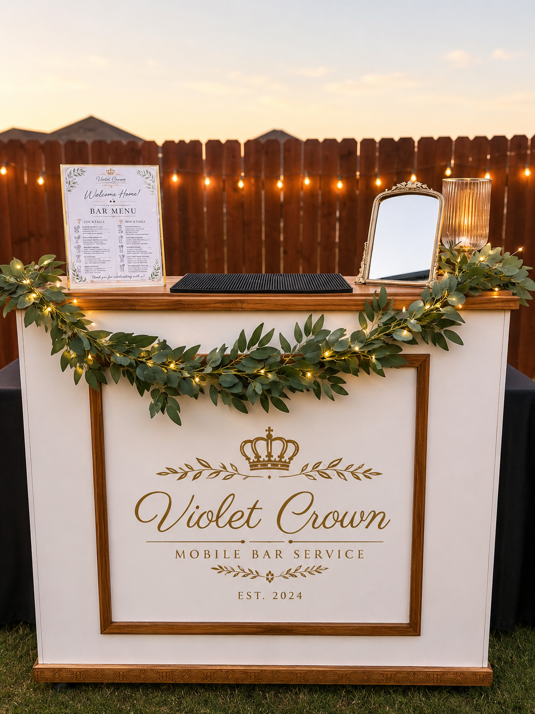 Branded mobile bar setup with custom signage at an event